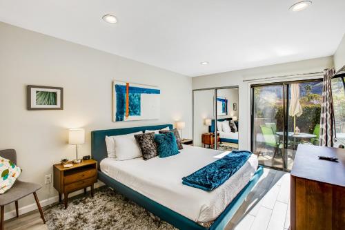 a bedroom with a bed and a balcony at Casa de Oasis Permit# 549 in Palm Springs