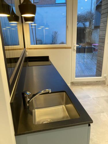 a kitchen counter with a sink and a window at Appart' Au Coeur de Nuits in Nuits-Saint-Georges