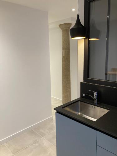 a bathroom with a sink and a mirror at Appart' Au Coeur de Nuits in Nuits-Saint-Georges