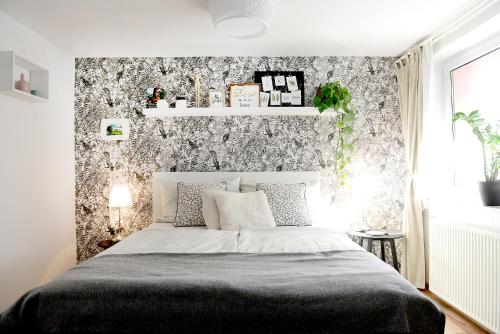 a bedroom with a bed with a black and white wallpaper at Apartma Amelie in Bled