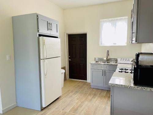 a kitchen with a refrigerator and a sink at Dawson’s Hideaway in Nassau