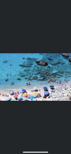 a beach with a bunch of items on the sand and water at Appartamento da Antonio in Parghelia