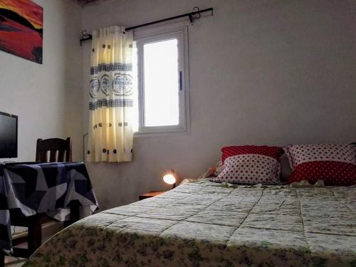 a bedroom with a bed and a window at IVATO Airport STUDIOS CHAMBRES in Ivato
