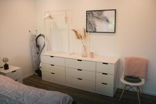 a bedroom with a dresser and a bed at Herz-Oase in Eigeltingen