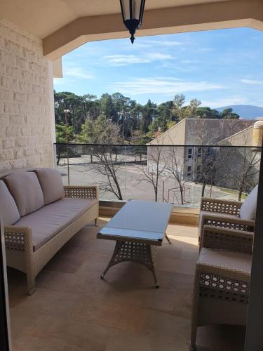 a living room with a couch and a table at Apartmani Tip-Top in Tivat
