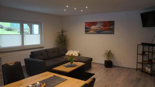 a living room with a couch and a table at Ferienwohnung Renke in Alberode