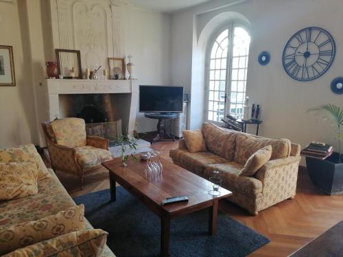 ein Wohnzimmer mit 2 Sofas und einem Couchtisch in der Unterkunft Chambre d hôte de la paix in La Rochefoucauld