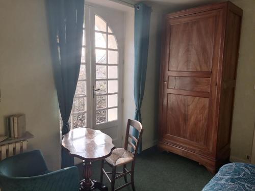 a room with a table and chairs and a window at Chambre d hôte de la paix in La Rochefoucauld