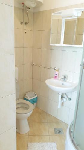 a bathroom with a toilet and a sink at Apartmani Paron Šime in Seline