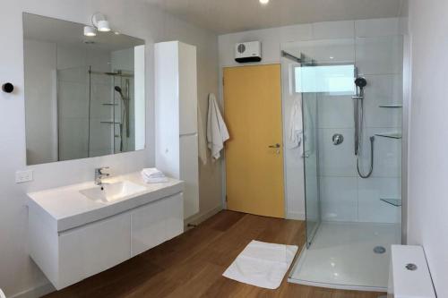 a bathroom with a sink and a shower at The Yellow Door in Wanaka