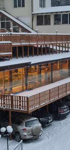 a building with cars parked in the snow at 7Soapte in Braşov