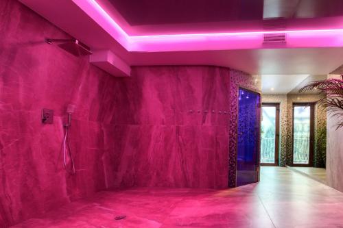 a pink room with a shower and a purple ceiling at Hotel & Spa Biały Dom in Gliwice