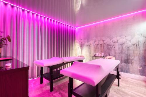 a pink salon with two pink stools in a room at Hotel & Spa Biały Dom in Gliwice