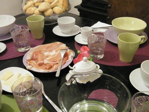 a table with plates of food and glasses on it at B&B Il Glicine in Montefollonico