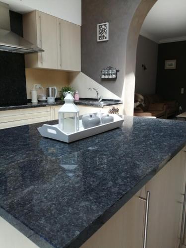 a kitchen with a counter top with a sink at Huize La Passion vacationhouse 10 min walk from the sea in Middelkerke