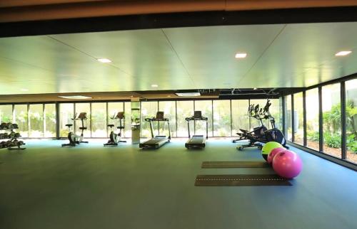 a gym with treadmills and elliptical machines and windows at Marvest Hua Hin flat B 208 3.fl. Betw.Soi 78-80 in Hua Hin