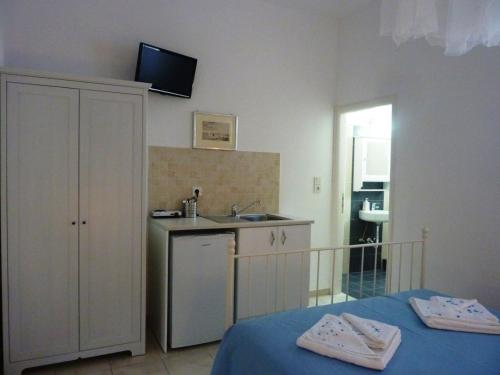 a room with a kitchen with a sink and a counter at ONAR STUDIOS MILOS Junior in Adamantas