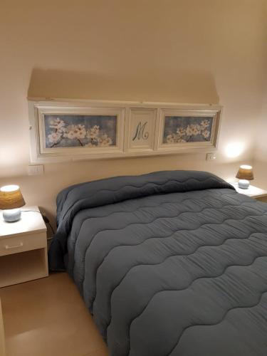 a bedroom with a bed with two night stands and two lamps at San Domenico Casa Vacanze in Modica