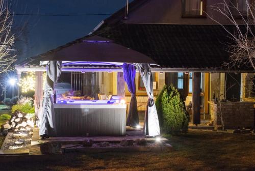 a gazebo in front of a house at night at "Vučedol"- kuća za odmor **** in Vukovar