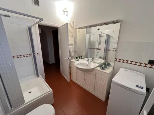 a bathroom with a toilet and a sink and a mirror at Rocca di Corno Guest House in Finale Ligure