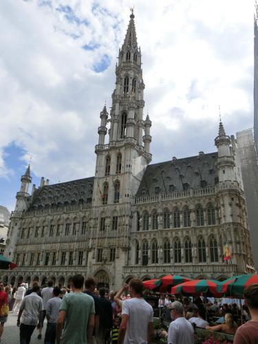 a large building with a clock tower in front of it at Hotel Aviation in Brussels