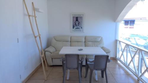 a living room with a couch and a table and chairs at Le BDM PLAYITA in Las Galeras