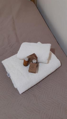 a white towel on a bed with a box on it at Posada Mis Padres in Godoy Cruz