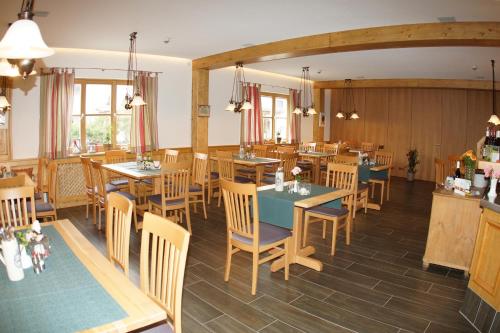 a restaurant with tables and chairs in a room at Landhotel Schöll in Parsberg