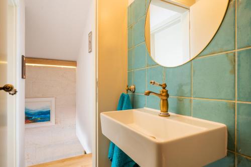 a bathroom with a sink and a mirror at Olive Park House Brač in Povlja