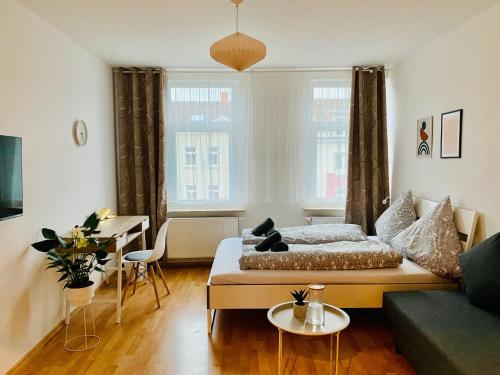 a living room with a bed and a couch at Modern & cozy Rooms Leipzig-Gohlis in Leipzig