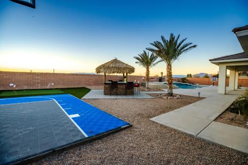 a swimming pool with a table and a umbrella at 3400 SqFt House W/40Ft Heated Pool/Spa- Strip View in Henderson