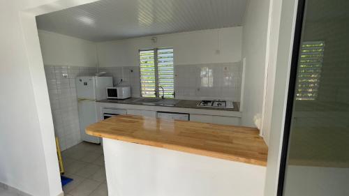 a kitchen with a wooden counter top in a room at LA DESIOR in Saint-Louis