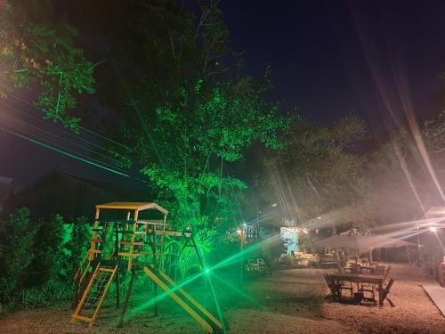 a park at night with a playground with lights at Vila Alegria in Bombinhas