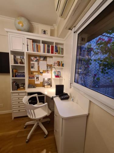 a home office with a desk and a window at Avenida Las Heraas in Buenos Aires