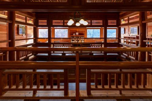 an empty church with wooden benches and windows at Towada Hotel in Kosaka