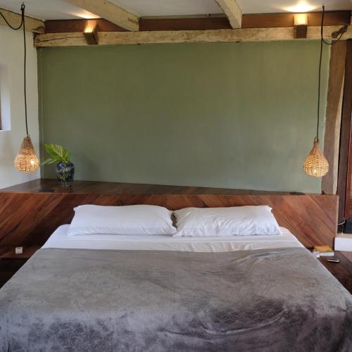 a bedroom with a large bed with two pillows at BOA BOA Bacalar in Bacalar