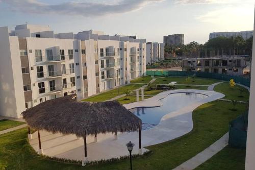 a resort with a swimming pool and a straw roof at ACAPULCO DIAMANTE!! HERMOSO DEPARTAMENTO NUEVO!! in Acapulco