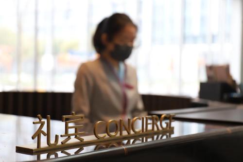 a woman wearing a gas mask in an office at Crowne Plaza Shanghai Hongqiao by IHG in Shanghai