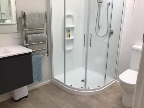 a bathroom with a shower with a glass door at THE AMBERS in Thames