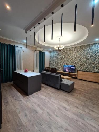 a living room with a couch and a table at Nino's Cosy Apartment in Kutaisi