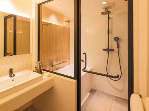 a bathroom with a sink and a shower at Hotel Muso in Kyoto