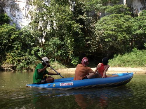 a group of people riding on a raft in the water at Khao Sok Palmview Resort in Khao Sok