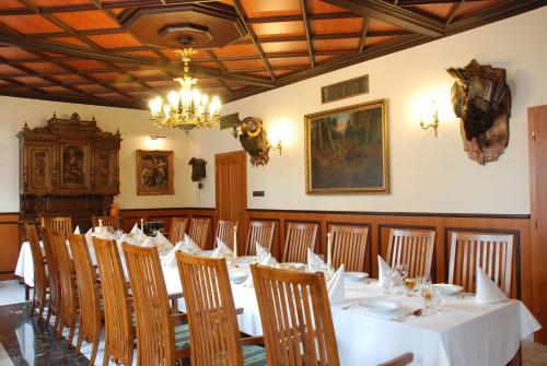 a dining room with a long table and chairs at Hotel Most Slávy in Trenčianske Teplice