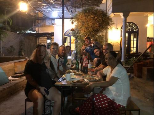 a group of people sitting around a table at Seconds Hostel - Colombo in Colombo