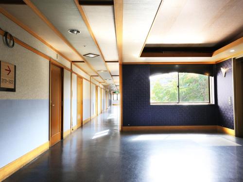 an empty hallway of an office building with a window at YU-FURI Nasu-Shiobara in Nasushiobara