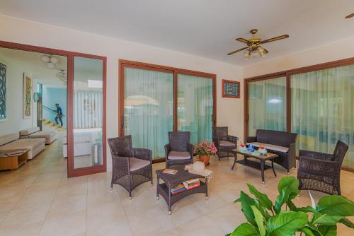 a living room with furniture and a ceiling fan at Hotel Ristorante Il Vascello in Costa Rei