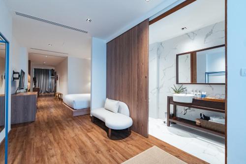 a bathroom with a sink and a mirror at QUU HOTEL Chiang Mai in Chiang Mai