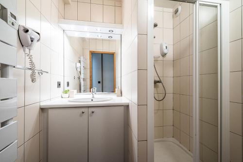 a bathroom with a sink and a shower at Eden Hotel, Apartments and Chalet Chamonix Les Praz in Chamonix-Mont-Blanc