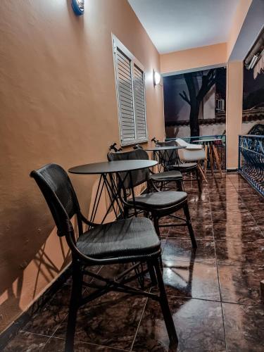 a row of tables and chairs in a room at The Bearded Dad Hostel in Tirana