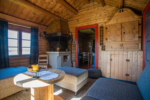 a living room with a couch and a table in a cabin at Olestølen in Skammestein